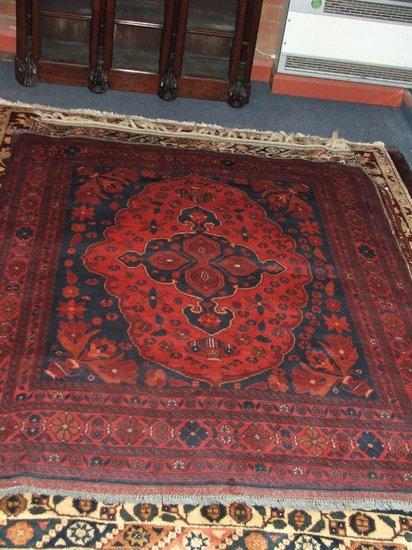 Appraisal: A TURKOMAN WINE GROUND RUG - decorated a central medallion