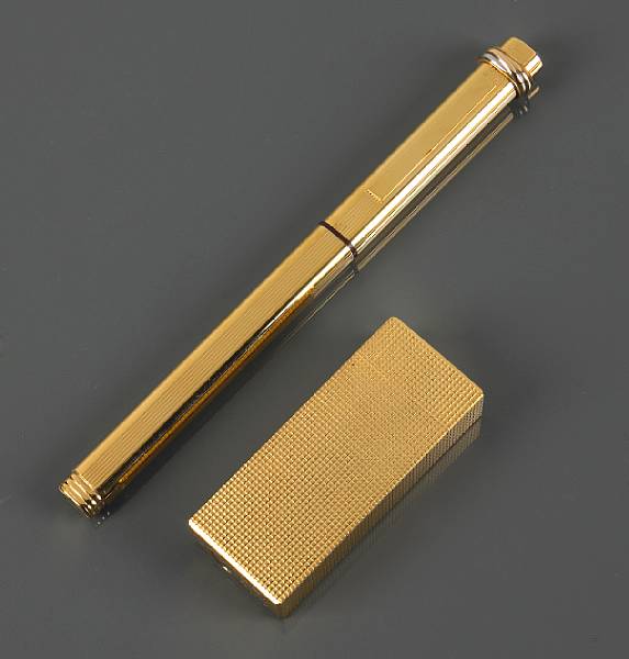 Appraisal: A gold plated lighter and pen les must de Cartier