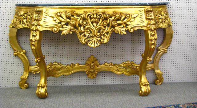 Appraisal: Marble top console table with heavily carved gold gilt wooden