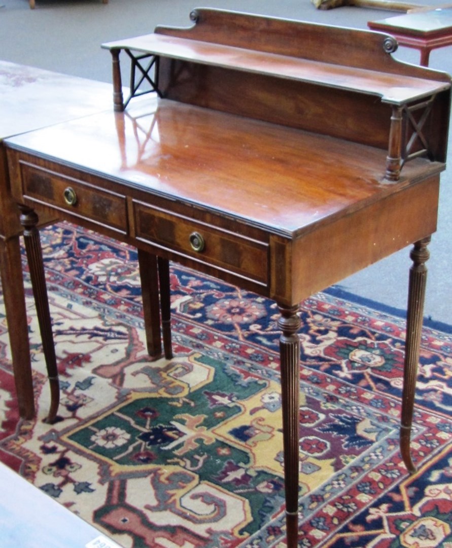 Appraisal: A George III style mahogany ledge back two drawer writing