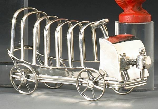 Appraisal: A motorist's toast rack British circa silver plated with wheels