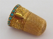 Appraisal: A late Victorian two-colour gold thimble with band of turquoise