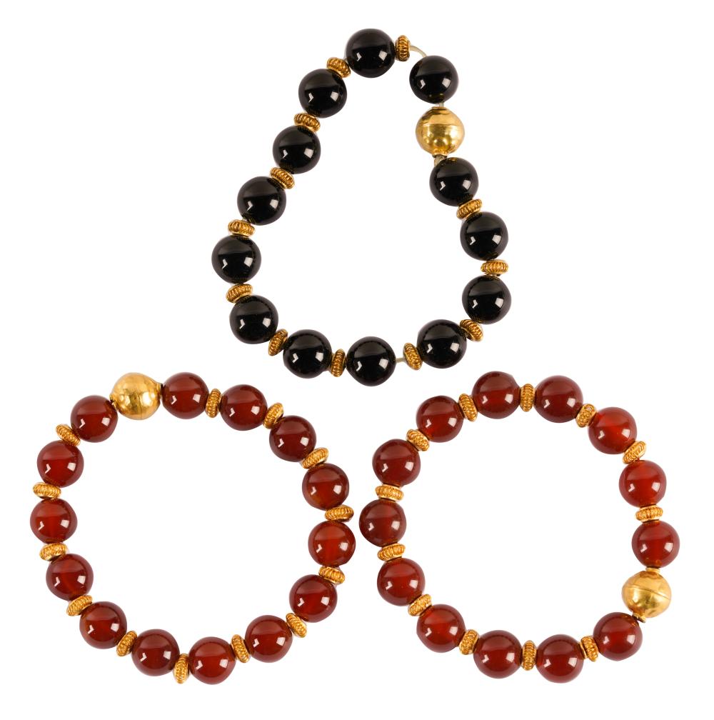 Appraisal: THREE KARAT YELLOW GOLD CARNELIAN ONYX BEADED BRACELETScomprising one black