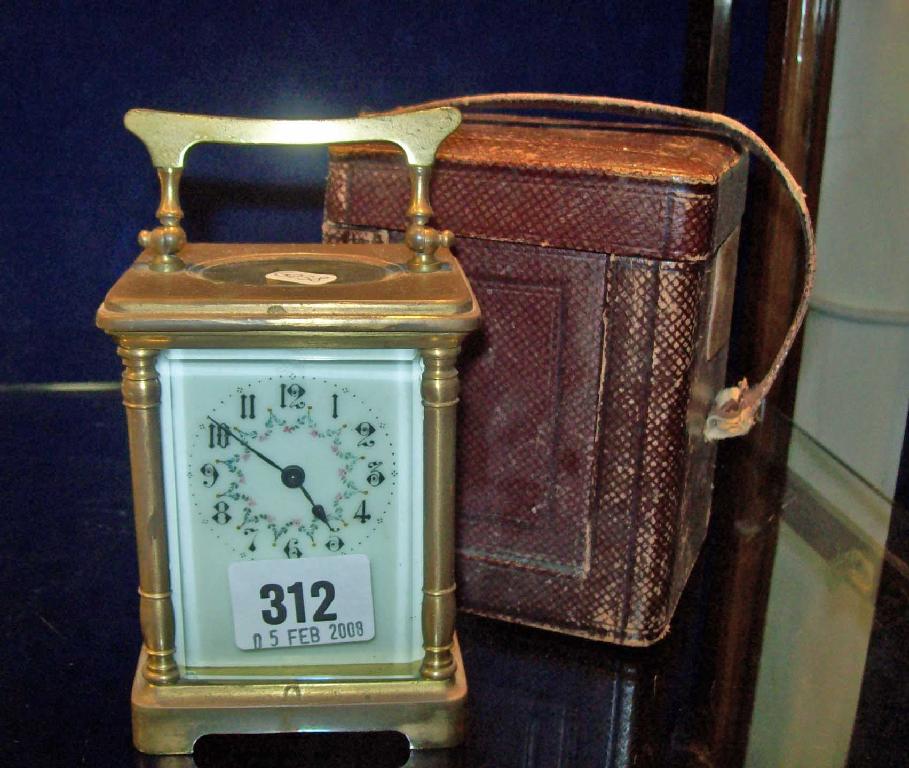 Appraisal: A carriage clock with decorated dial in leather carrying case