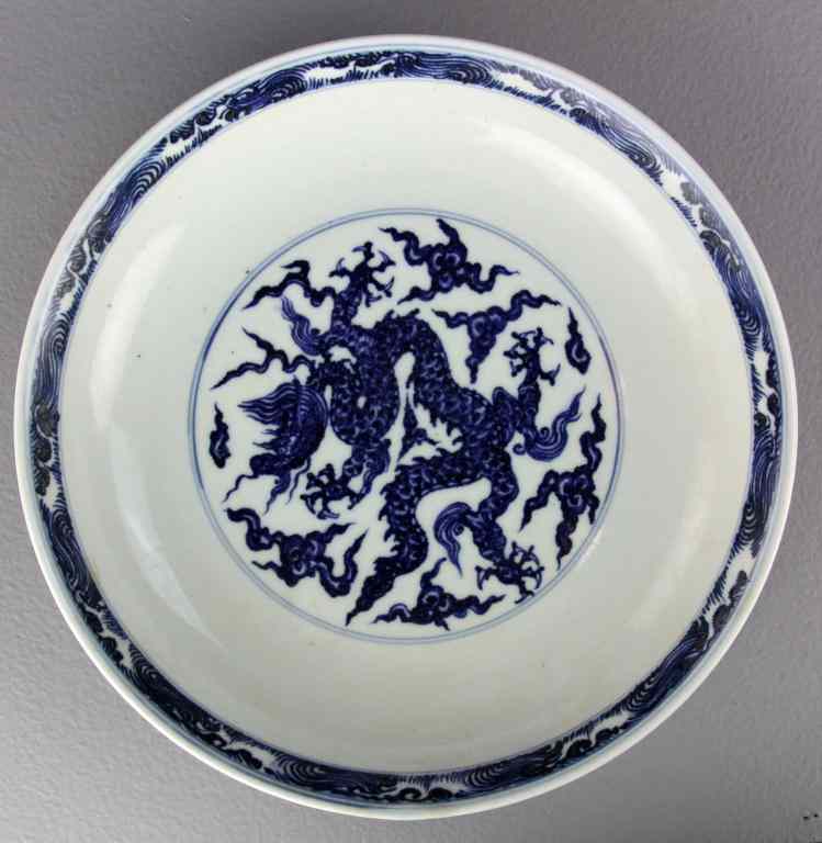 Appraisal: Chinese Blue White Porcelain DishFinely painted to depict dragons amongst