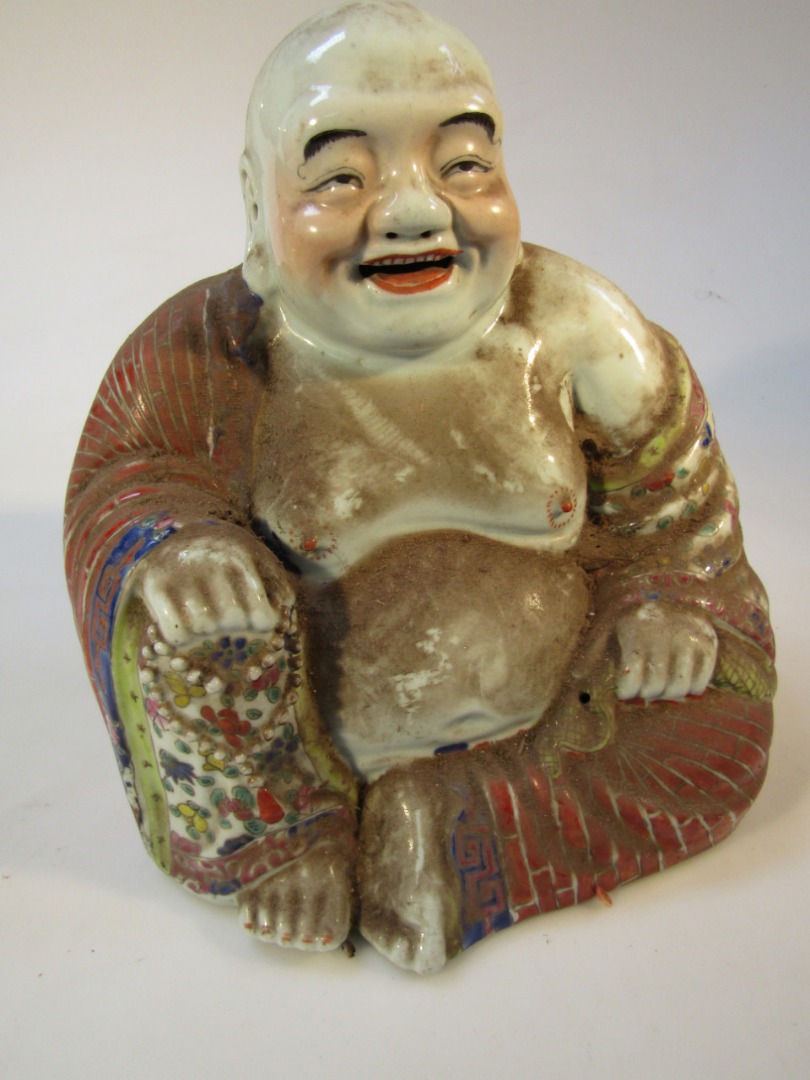 Appraisal: A Chinese porcelain figure of a seated Buddha scantly clad