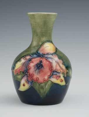 Appraisal: A Moorcroft Orchid Design Glazed Ceramic Vase With a rich