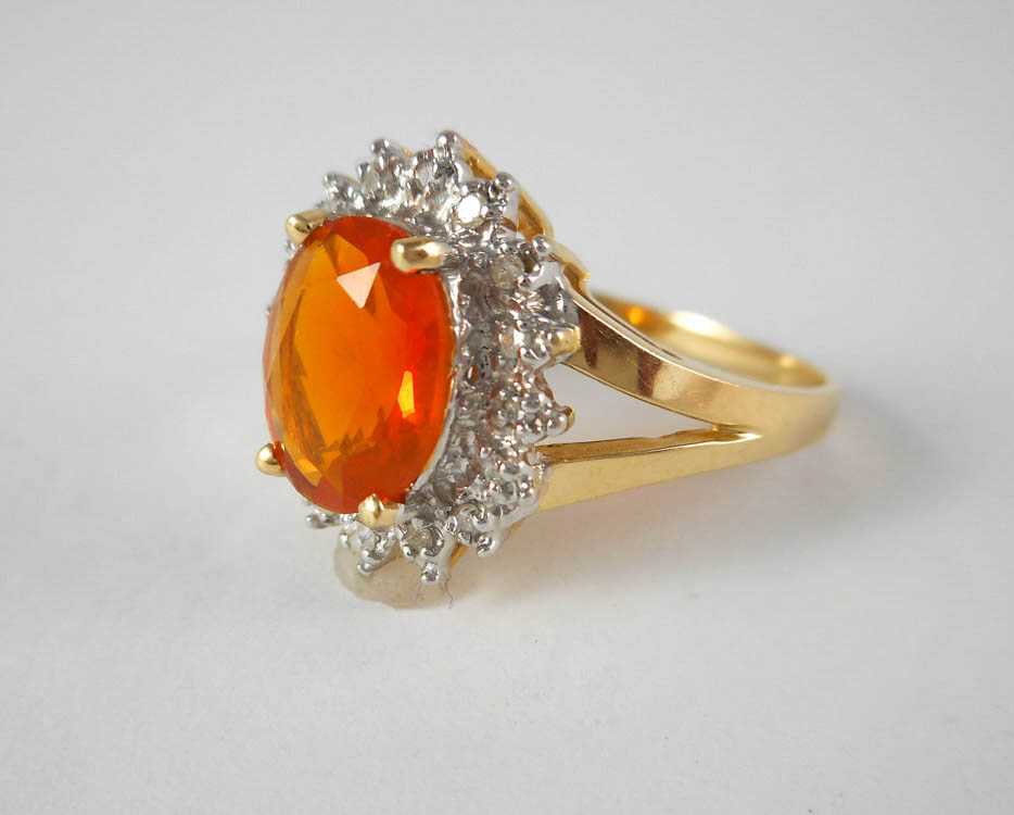 Appraisal: FIRE OPAL DIAMOND AND FOURTEEN KARAT GOLD RING The yellow