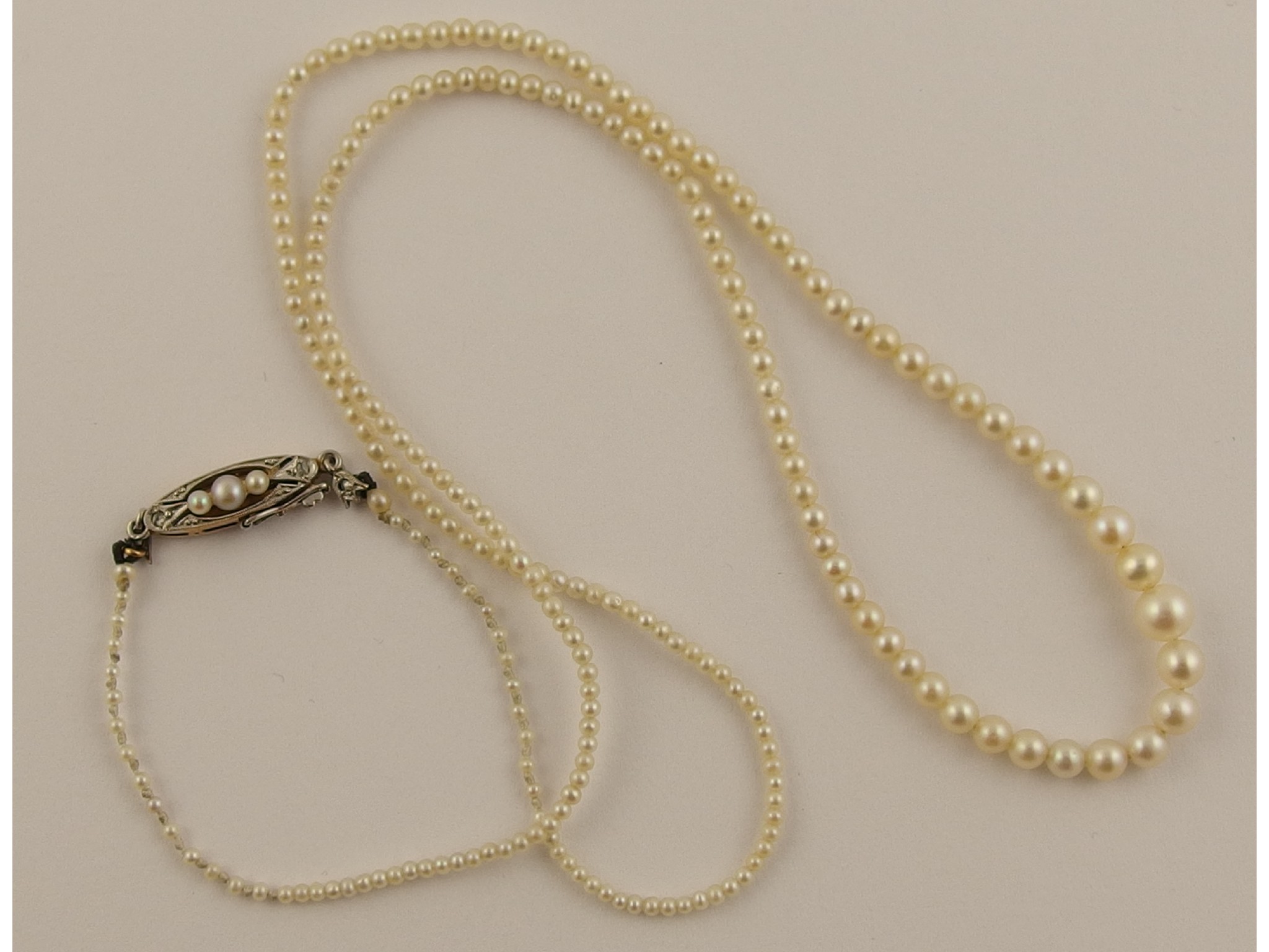 Appraisal: A delicate string of child's pearlswith a diamond and pearl