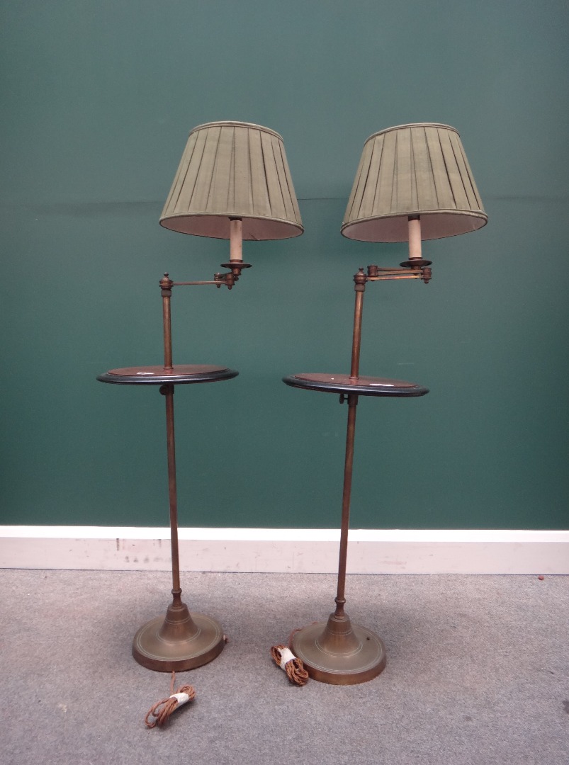 Appraisal: A pair of brass adjustable standard lamps th century with