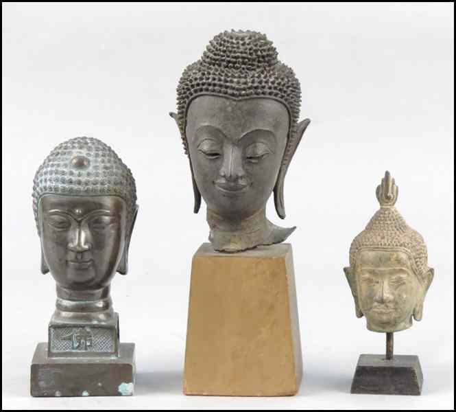 Appraisal: THREE PATINATED BRONZE BUDDHA HEADS Tallest '' Condition No Specific