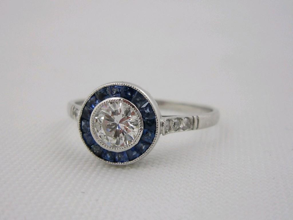 Appraisal: A Diamond and Sapphire Cluster Ring pav-set circular-cut diamond within