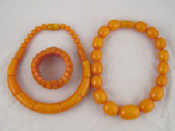 Appraisal: Two faux amber bakelite necklaces each approx cm long and