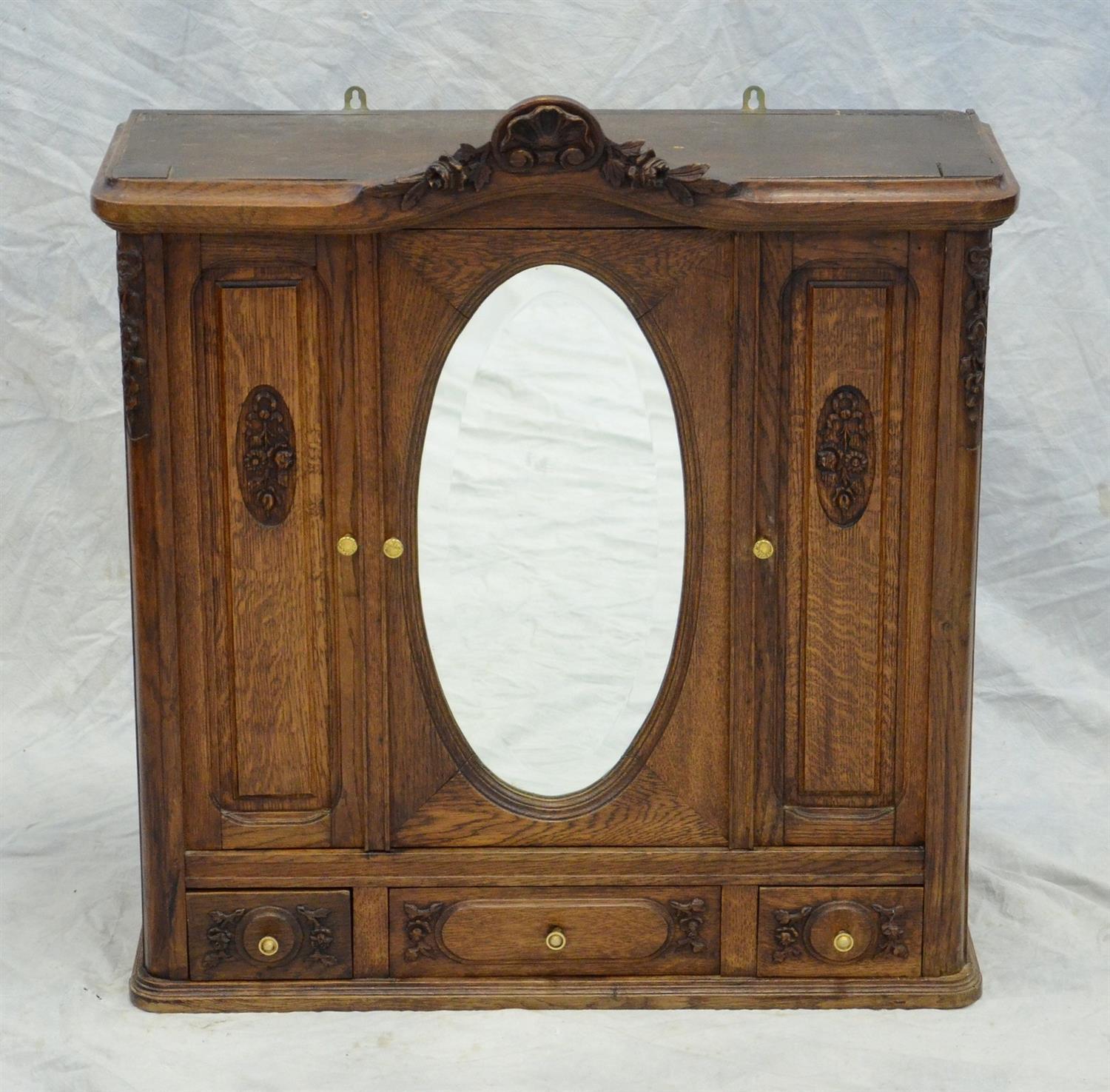 Appraisal: Continental carved oak hanging cabinet bifold double door with another