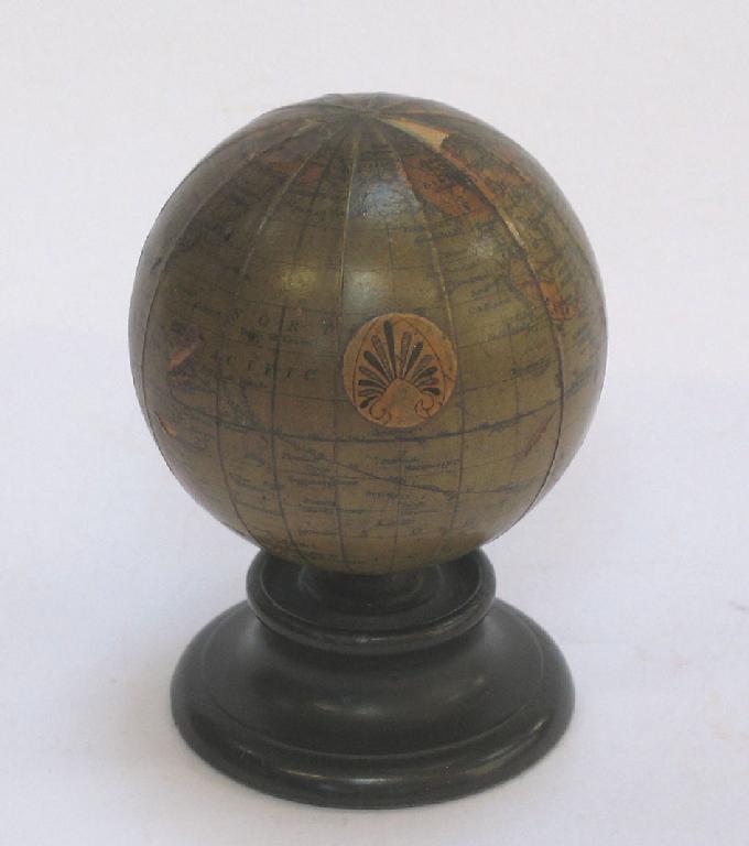 Appraisal: A MINIATURE DESK GLOBE marked with an anthemion scroll on