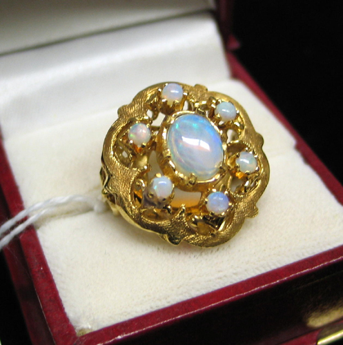 Appraisal: OPAL AND FOURTEEN KARAT GOLD RING Six round opal cabochons