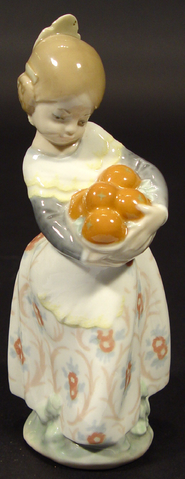 Appraisal: Lladro porcelain figurine 'Valencian girl clutching a basket of oranges'