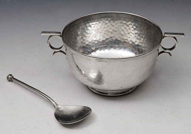 Appraisal: A SILVER PORRINGER with two loop handles hand beaten finish