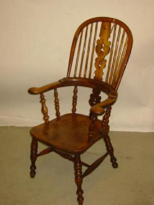 Appraisal: AN ASH AND ELM WINDSOR ARMCHAIR of double hoop high