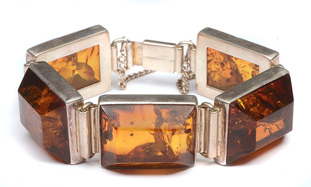 Appraisal: A SILVER AND AMBER BRACELET with five facet cut panels