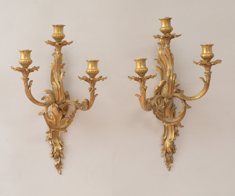 Appraisal: PAIR OF LOUIS XV STYLE GILT-BRONZE THREE-LIGHT WALL SCONCES Each