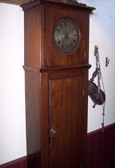 Appraisal: An oak cased warder's clock the silvered dial with Roman