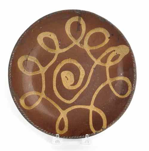 Appraisal: New England redware plate th c with yellow slip loop