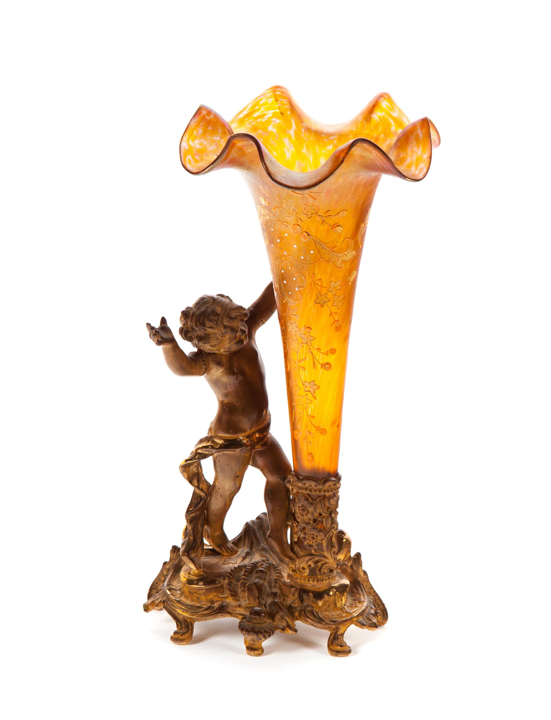 Appraisal: VICTORIAN ART GLASS EPERGNE WITH FIGURAL BASE Gilded putti holding