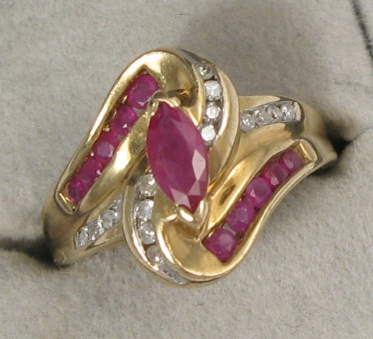 Appraisal: RUBY DIAMOND AND EIGHTEEN KARAT GOLD RING centering a marquise-cut