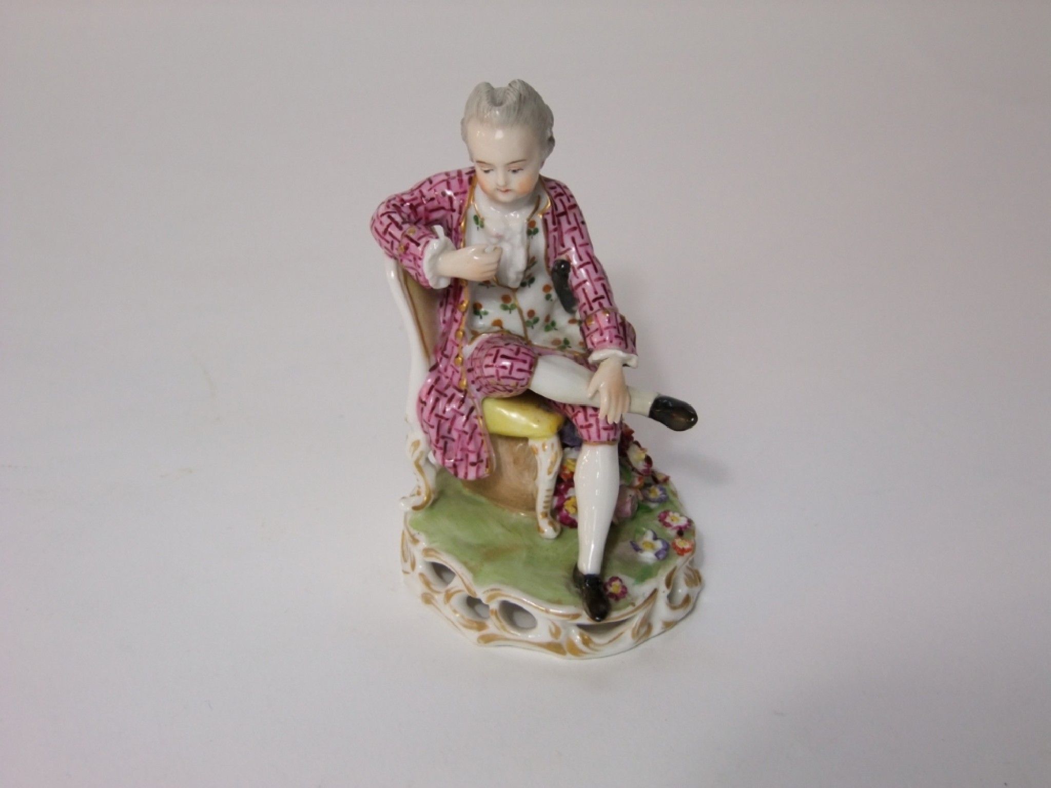 Appraisal: A th century ceramic figure of a seated gentleman in