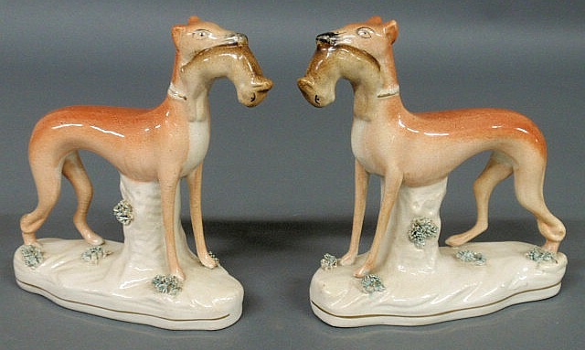 Appraisal: Pair of English Staffordshire standing whippets with game c h