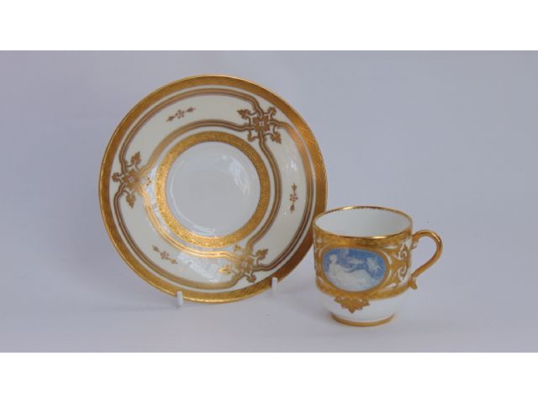 Appraisal: A Mintons cabinet cup and saucer with two oval Pate-Sur-Pate