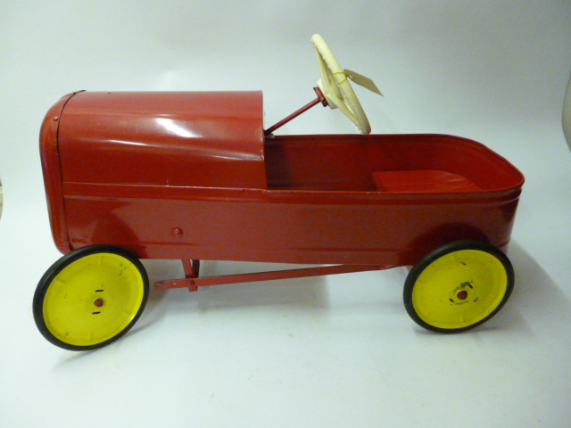 Appraisal: A tinplate pedal car late 's 's with steering wheel