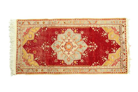 Appraisal: ORIENTAL RUG Oushak Floral medallion on red ground Some wear