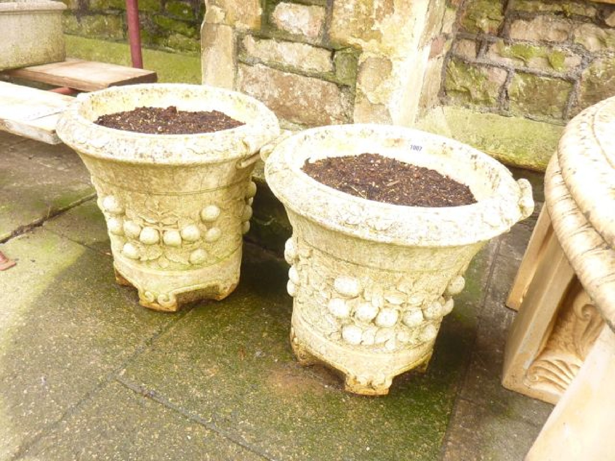 Appraisal: A pair of reconstituted garden planters of circular form with