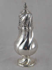 Appraisal: A large and heavy silver caster with swirl fluting and