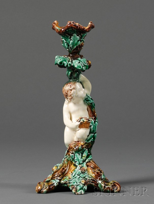 Appraisal: Wedgwood Majolica Figural Candlestick England c modeled as a cherub