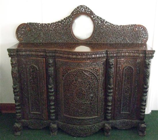 Appraisal: A BURMESE HARDWOOD SERPENTINE FRONTED SIDE CABINET with three doors