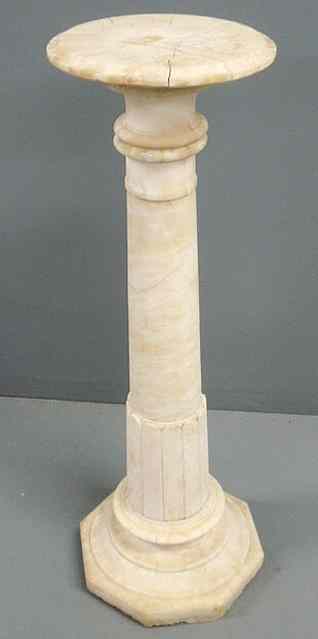 Appraisal: Carved alabaster pedestal with a circular top and octagonal base