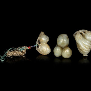 Appraisal: Three Chinese Jade Carvings of Fruits comprising a pomegranate example