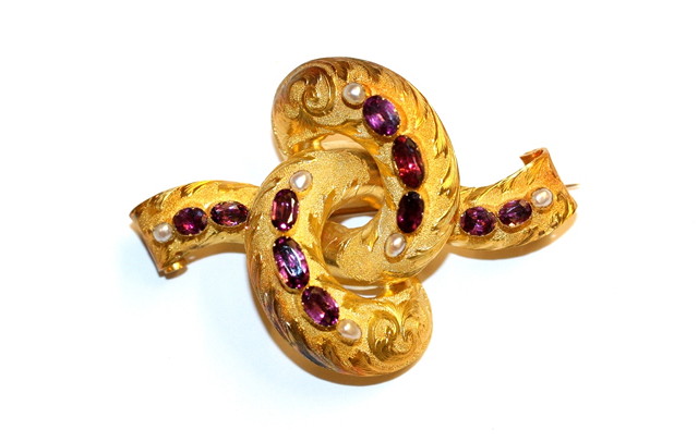 Appraisal: A RUBY SET BROOCH in the form of a flower