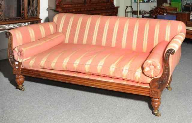 Appraisal: A REGENCY ROSEWOOD DOUBLE ENDED SOFA with carved leaf frame