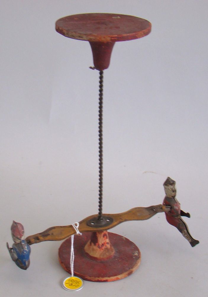 Appraisal: TIN TOPSY TURVY TOY In red and yellow paint Paint