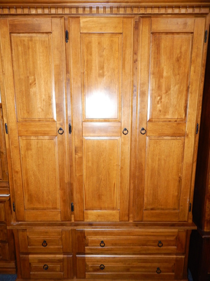 Appraisal: An oak double wardrobe with dentil moulded pediment over three