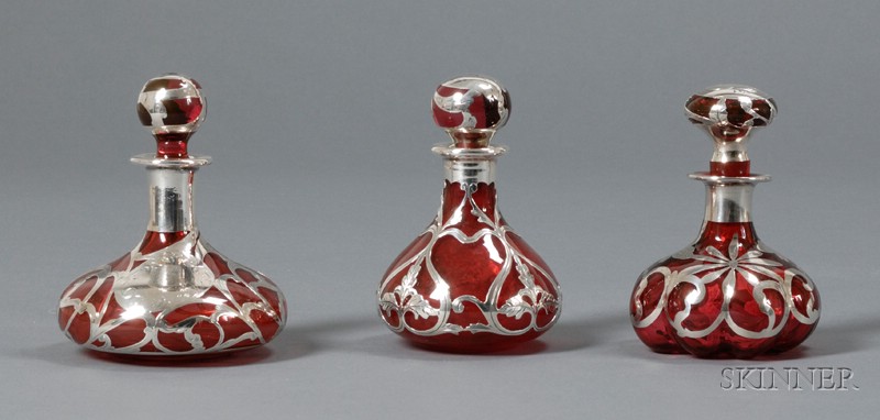 Appraisal: Three Silver Overlay Colognes Glass and silver th century Bulbous