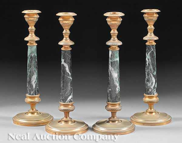 Appraisal: A Set of Four Bronze and Verde Antico Marble Candlesticks