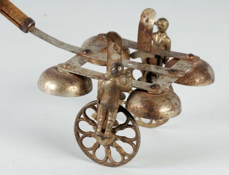 Appraisal: Early Cast Iron Tin Bell Toy Description When pushed wheels