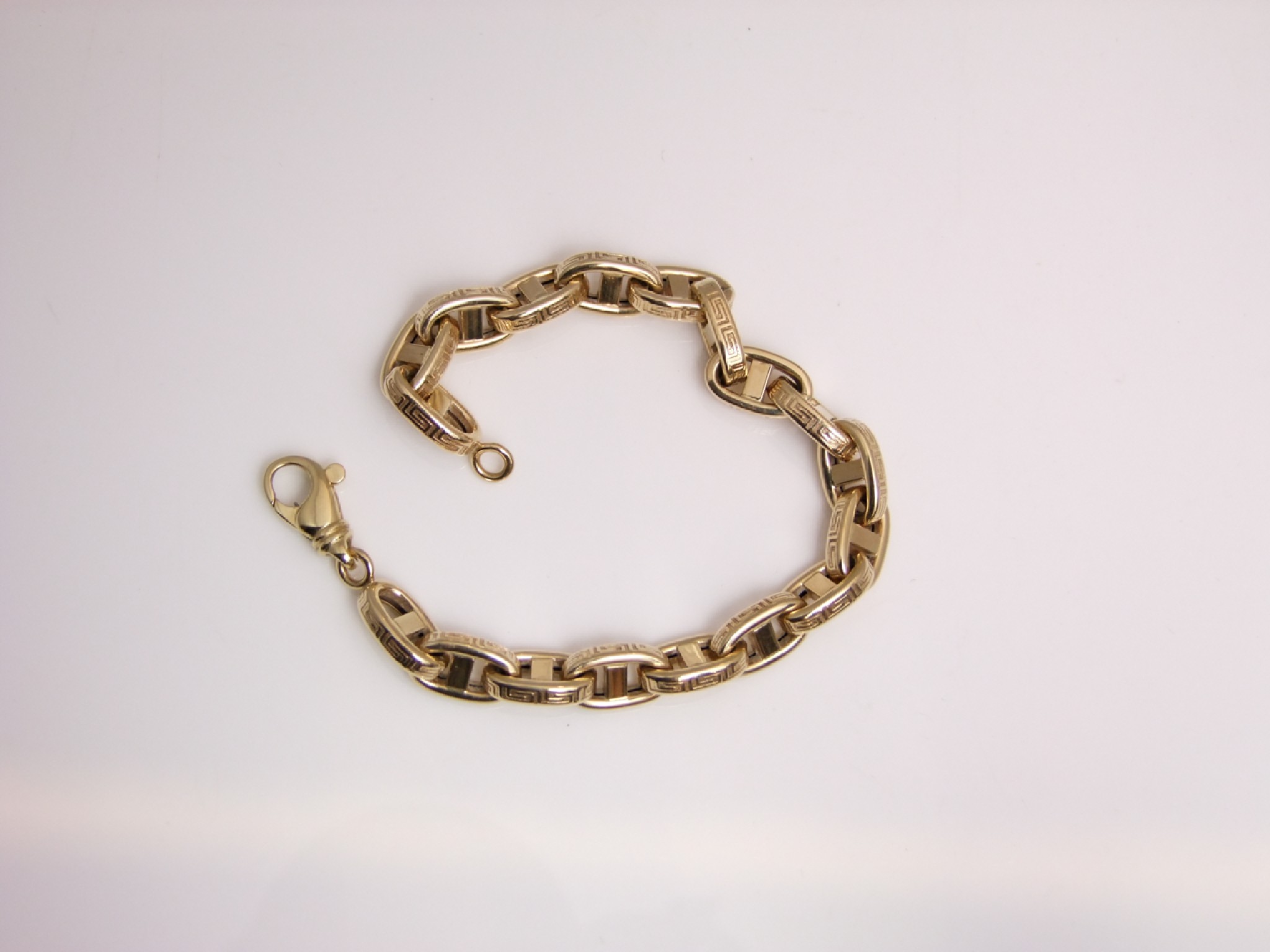 Appraisal: A ct gold Gucci-link bracelet each link with Greek Key