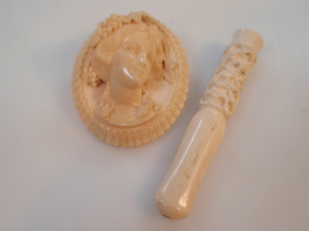 Appraisal: A Victorian carved ivory portrait brooch with a female head