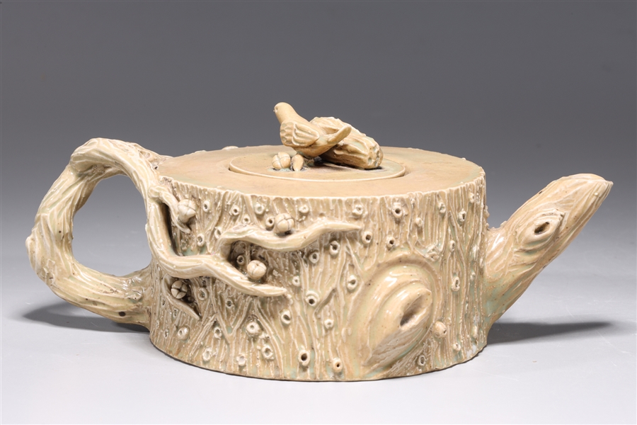 Appraisal: Elaborate Chinese porcelain teapot with molded tree design to body